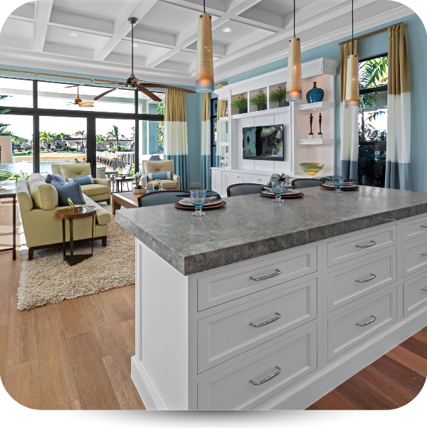 modern kitchen island overlooking living room with built ins and large windows